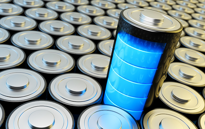 The image shows a blue glowing battery sticking out of a sea of battery heads.